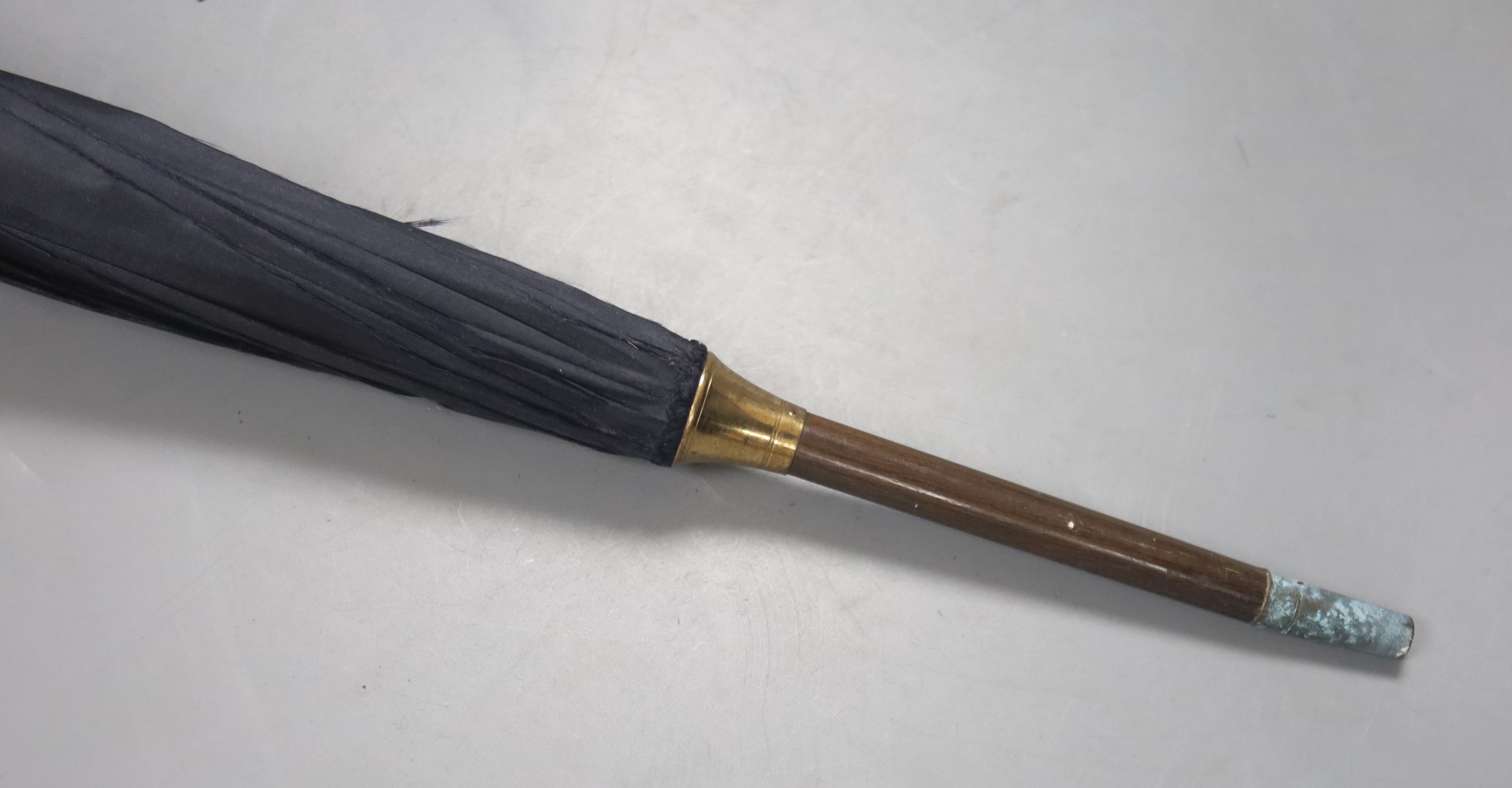 A Victorian umbrella with rosewood mother of pearl and abalone handle